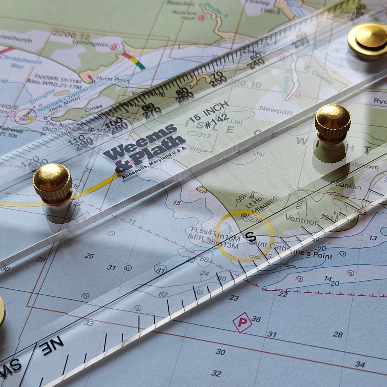 Navigational tools set in a wooden box lined with gray fabric. Includes a dividers, a compass, and a scale ruler. The box has metal clasps and is open to display the instruments.
