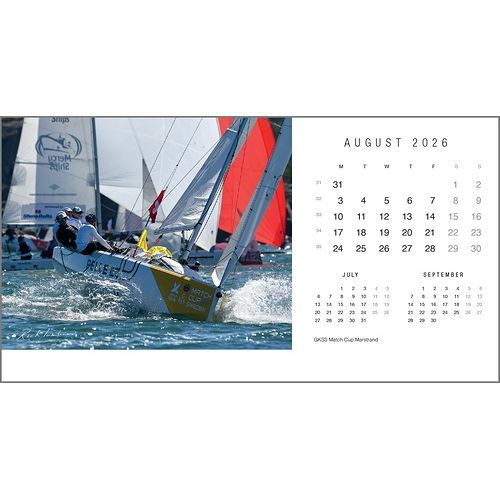 Two sailboats race across the water, their sails billowing. On the right is the Rick Tomlinson Desk Calendar 2026 by Rick Tomlinson Photography, open to August with stunning yachting imagery; July and September mini calendars are shown below.