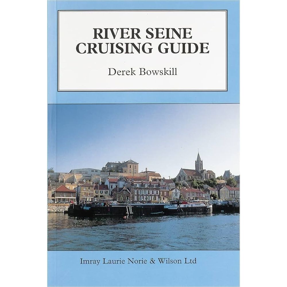 Cover of the "River Seine Cruising Guide" by Derek Bowskill. The image beautifully depicts French waterways with a scenic riverside view showcasing picturesque buildings and a church under a clear blue sky. Published by Imray.