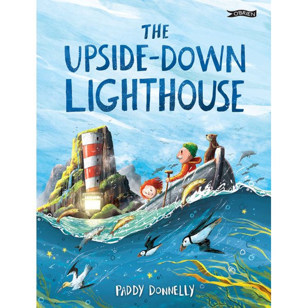 The illustrated cover of O'Brien Press’s "The Upside-Down Lighthouse" shows two children and a dog in a boat by a rocky island lighthouse, with swirling blue clouds, waves, and birds.