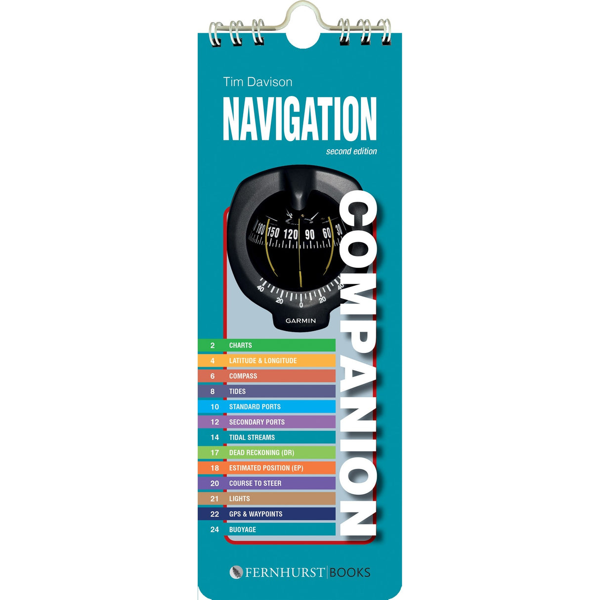 Navigation Companion" by Fernhurst Books is a spiral-bound guide with a blue cover featuring a compass image and a colorful topic index for charts, tides, GPS, buoys, and more—ideal for onboard navigation.