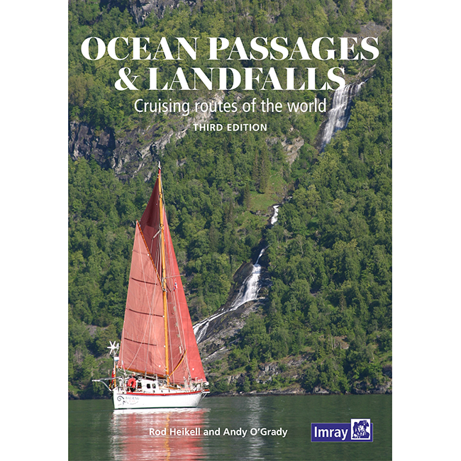 Imray's "Ocean Passages & Landfalls" by Rod Heikell and Andy O'Grady, features a picturesque cover of a sailboat with red sails on a lake surrounded by green hills and a waterfall. This third edition cruising guide is perfect for ocean voyagers seeking global routes.