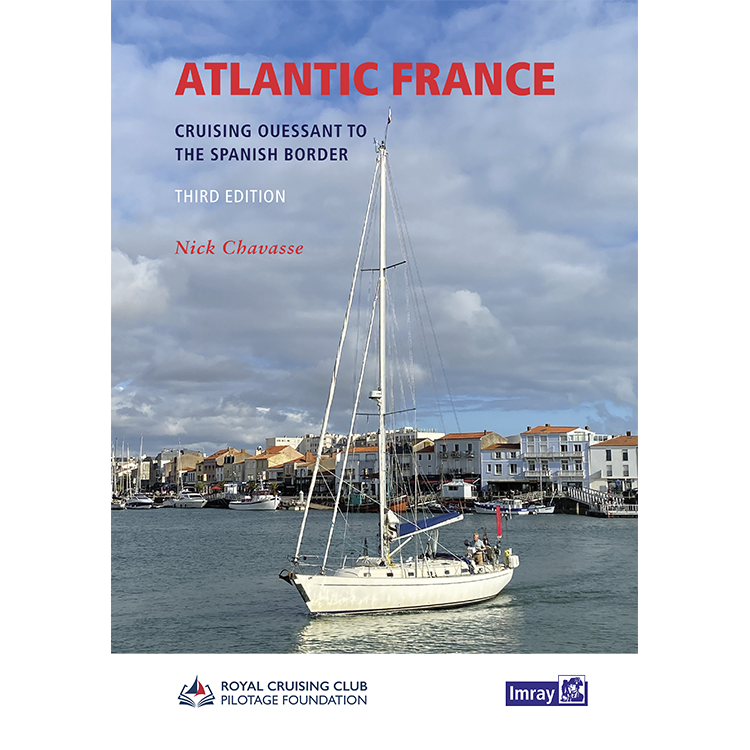 A white sailboat floats in a calm harbor, lined with red-roofed houses under a blue sky. The book title "Atlantic France" by Imray is overlaid, showcasing this essential cruising guide for exploring the Atlantic coast.
