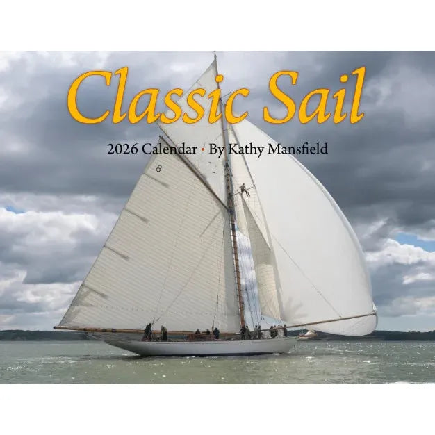 A white sailboat with tall sails drifts on calm water beneath clouds. Text: "Classic Sail 2026 Calendar · Kathy Mansfield." Ideal for classic sailboat enthusiasts and nautical photography fans.