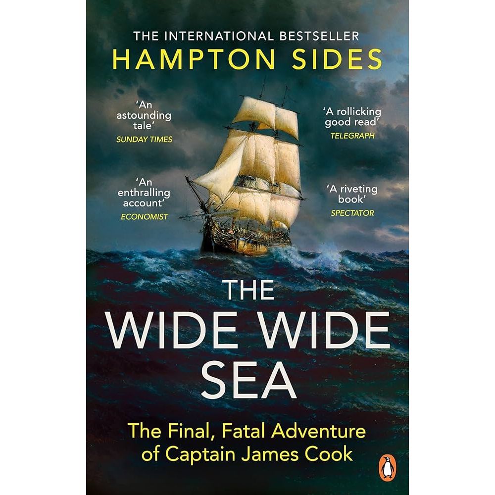 The Penguin Books cover for "The Wide Wide Sea" by Hampton Sides showcases an old sailing ship, similar to the HMS Resolution, navigating a stormy sea. Features quotes from The Sunday Times, Telegraph, Economist, and Spectator with the Penguin logo at the bottom.
