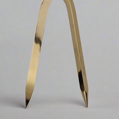 Close-up of the Chartwright 7" Single-Handed Brass Dividers with two pointed legs extended, used for measuring distances on maps or technical drawings. The background is neutral gray, emphasizing the polished metallic surface of this precision instrument from Chartwright.