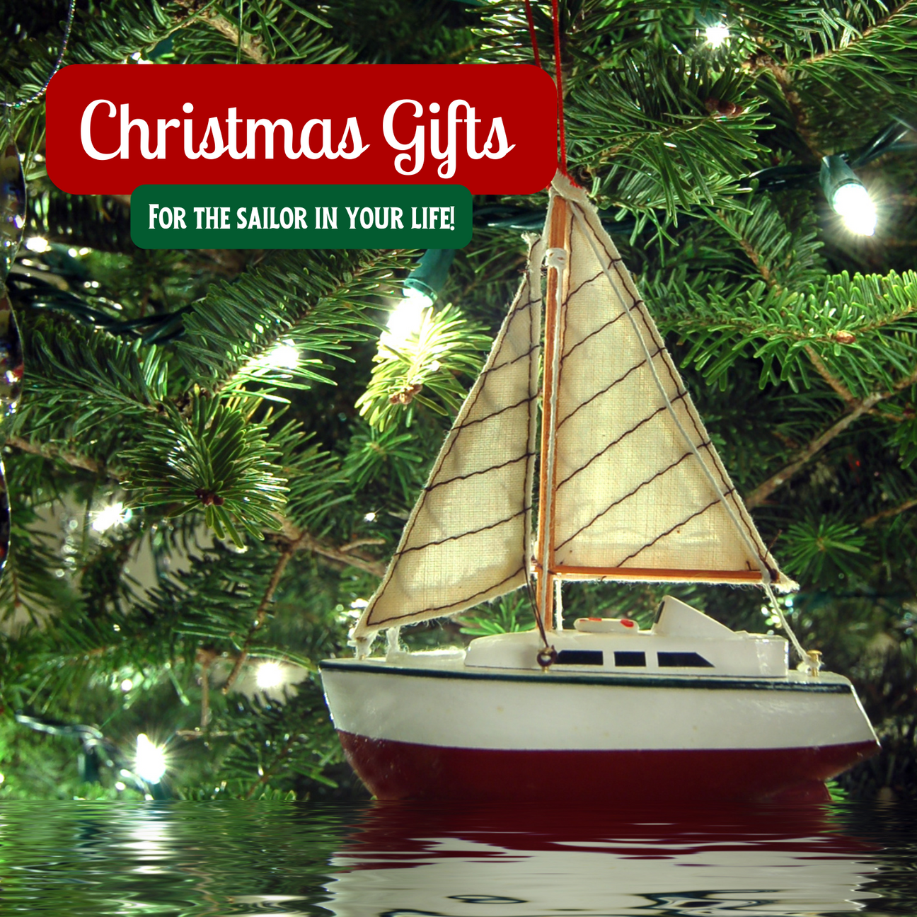 A wooden model sailing boat with a backdrop of a Christmas Tree and Fairy Lights.