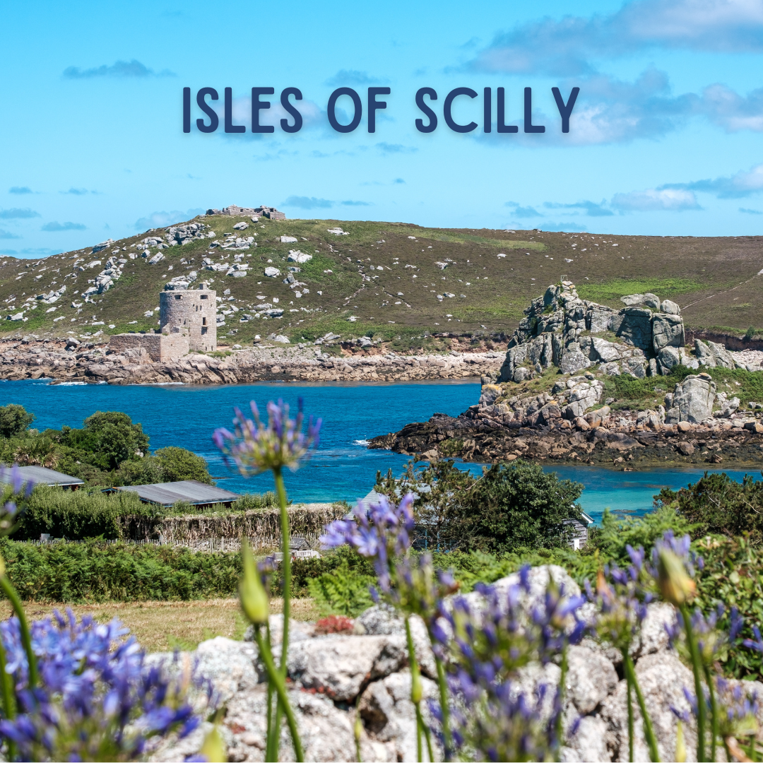 A scenic view of the Isles of Scilly with rocky hills, a stone building, and a vibrant blue sea. Purple flowers and greenery frame the foreground. A red label reads "Isles of Scilly.