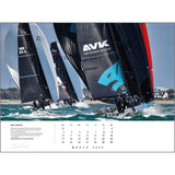 Sailboats navigate through choppy waters under clear skies, each adorned with unique sails. The lead sail boasts a blue logo as crew members maneuver skillfully. The foreground boat's sail is emblazoned with "AVK." At the bottom is the Rick Tomlinson Photography's Rick Tomlinson Portfolio Calendar 2025, featuring March 2025.