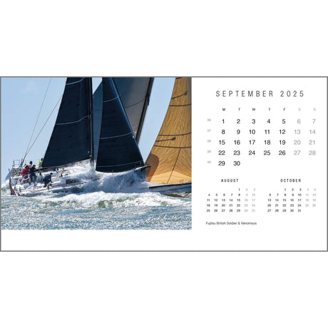 This breathtaking image from the Rick Tomlinson Desk Calendar 2025 by Rick Tomlinson Photography features sailboats racing across the ocean beneath clear skies. Two boats with striking dark and gold sails command attention. The sailing desk calendar highlights September 2025, also showcasing August and October.