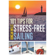 Cover of "101 Tips for Stress-Free Sailing" by Adlard Coles. Depicts a sailboat at sunset beside a lighthouse, embodying the spirit of nautical exploration. Features visuals of a boat deck, mast, lifebuoy, and seagull, providing guidance on sailing tips and mastering mooring techniques.