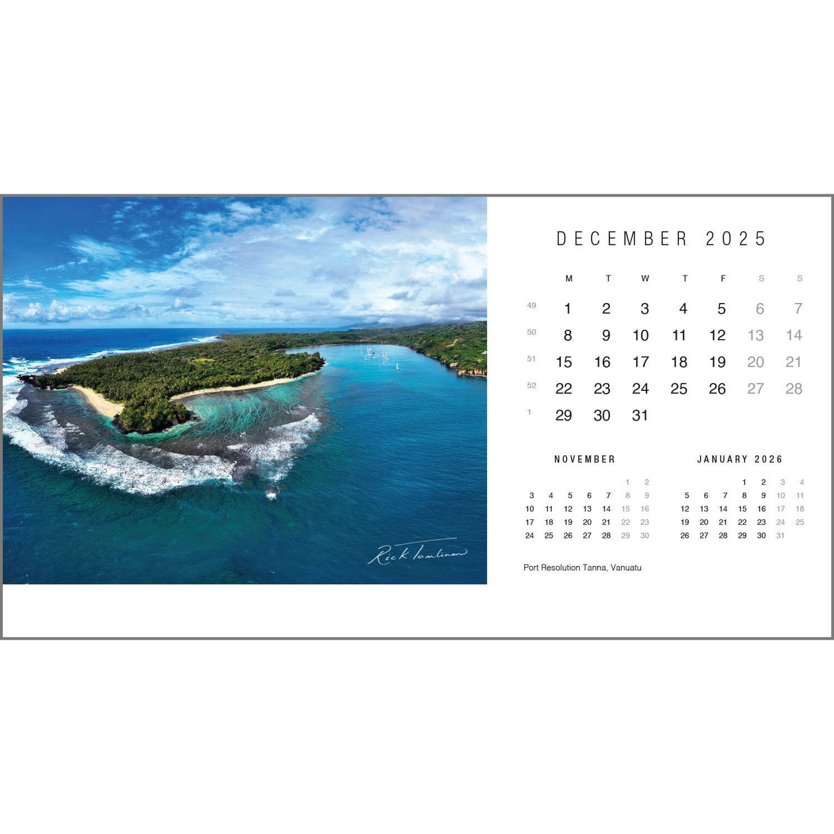 Aerial view of a tropical island with lush greenery and blue ocean waves resembles a scene from the Rick Tomlinson Desk Calendar 2025. The image displays the December 2025 calendar page alongside November and January, captioned as Port Resolution Tanna, Vanuatu by Rick Tomlinson Photography.