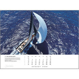 Aerial view of a sailboat with billowing sails gliding over deep blue water under a clear sky. Dates and text appear at the bottom of the Rick Tomlinson Portfolio Calendar 2026 by Rick Tomlinson Photography.