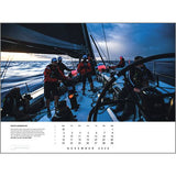 Sailors adjust sails and steer through choppy water at dusk in the Rick Tomlinson Portfolio Calendar 2026 by Rick Tomlinson Photography, featured as the November image for sailing enthusiasts.