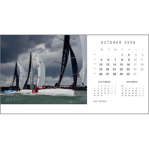 The Rick Tomlinson Desk Calendar 2026 by Rick Tomlinson Photography features October’s page with stunning sailboats racing under a cloudy sky, plus mini calendars for September and November below the main month.