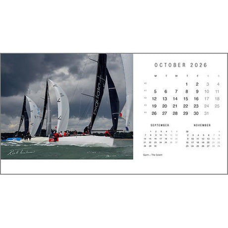 The Rick Tomlinson Desk Calendar 2026 by Rick Tomlinson Photography features October’s page with stunning sailboats racing under a cloudy sky, plus mini calendars for September and November below the main month.