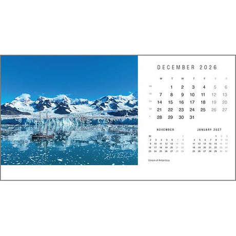 The Rick Tomlinson Desk Calendar 2026 by Rick Tomlinson Photography features a December page with a sailboat in icy Antarctic waters amid snow-capped mountains—ideal for yachting photography fans.