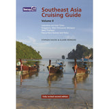 Cover of "Southeast Asia Cruising Guide - Volume II" by Imray, authored by Stephen Davies and Elaine Morgan. The cover showcases traditional boats on a tranquil sea set against lush, green cliffs. Text highlights regions included: Indonesia, East Timor, Singapore, West Malaysia and more. Perfect for round-the-world sailors looking for popular anchorages.