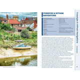 Image of a scenic riverbank with moored boats and quaint houses, similar to those along inland waterways. Right side features text from the Nicholson Waterways Guide 6: Nottingham, York and the North East about Fossdyke & Witham Navigations, detailing navigation dimensions, contacts, and heritage info.