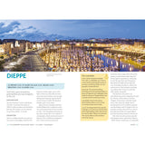 A scenic view of Dieppe harbor at twilight features boats docked along the Alabaster Coast. The sky forms a blue gradient, with the pier under glowing streetlights. Text overlays show tourist info and sailor guides from the Adlard Coles Shore Guide: Channel Coast of France by Adlard Coles.