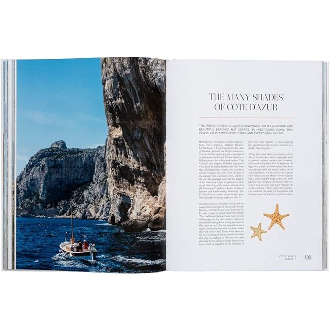 An open magazine spread featuring "Sailing the Seas" by gestalten showcases alluring sailing destinations with a scenic photo of a boat on azure waters near rocky cliffs, complemented by starfish images that evoke maritime culture.