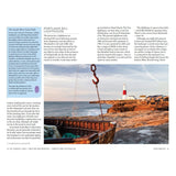 A scenic coastal view features the Portland Bill Lighthouse, highlighting maritime heritage with a rocky shore and an old wooden boat. Text about the South West Coast Path and Portland Bill Lighthouse is included. Explore with Adlard Coles Shore Guide: The West Country by Adlard Coles.