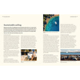 A magazine spread titled "Sustainable Sailing" features Adlard Coles' "Dream Cruising Destinations." The left page offers a guide with the “Top 20 Tips for Sustainable Sailing,” while the right showcases stunning images of a boat on clear water and a beach setting.