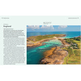 In "Dream Cruising Destinations" by Adlard Coles, enjoy a scenic aerial view of the Isles of Scilly with turquoise waters, sandy beaches, and rugged landscapes. Boats are anchored near the lush green terrain and rocky coastlines. Text about the Isles is on the left.