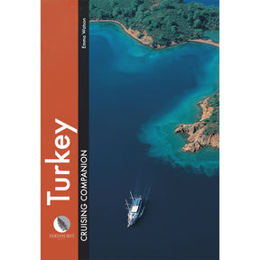 A yacht sails along Turkey’s lush coastline in the cover image of “Turkey Cruising Companion,” an essential guide from Fernhurst Books.