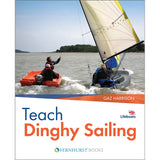 Two in a motorboat guide a dinghy with two sailors on open water. Book cover: "Teach Dinghy Sailing" by Fernhurst Books—a step-by-step sailing guide for teaching beginners to sail.