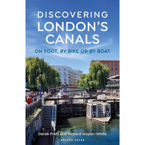 The cover of "Discovering London's Canals" by Adlard Coles beautifully depicts scenic routes along London’s historic waterways, showcasing people walking and cycling amidst lush trees, under a blue sky, with a picturesque bridge in view – capturing the essence of canal adventures.