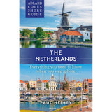 The "Adlard Coles Shore Guide: The Netherlands" by Adlard Coles features Dutch windmills, houses, and marina scenes, offering essential tips for sailing and exploring the Standing Mast Route in the Netherlands.