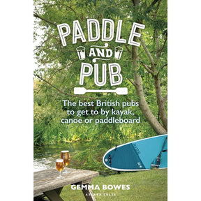 The book cover for "Paddle and Pub" by Adlard Coles features scenic UK waterways, with two pints of beer on a wooden table, a paddleboard nearby, and lush greenery enhancing the calm river view.