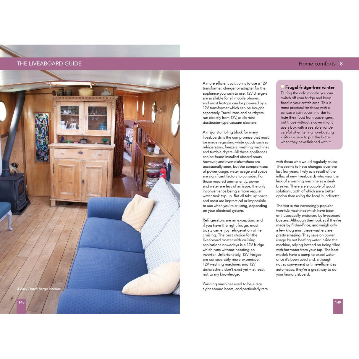 Experience the relaxing liveaboard lifestyle with The Liveaboard Guide by Adlard Coles—enjoy wood floors, a blue sofa with cushions, a wooden cabinet, and sunlit circular windows for a cozy boat interior.