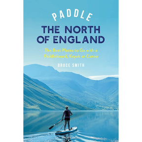 A person paddleboarding on a tranquil lake framed by mountains, capturing the North of England’s spirit, with "Paddle the North of England" by Adlard Coles shown above.