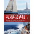 The cover of Adlard Coles' "The Complete Yachtmaster" shows yachts sailing at sea with a lighthouse in the background and waves splashing, reflecting seamanship and confidence.