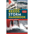 Reeds Storm Handbook book cover by Reeds features sailing boats battling large waves in rough seas, with "How to Survive Rough Weather" text over a blue and red background, emphasizing heavy weather sailing.
