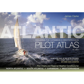 A sailboat crosses the ocean beneath cloudy skies, with distant land in view. The cover text reads "Atlantic Pilot Atlas" by James Clarke, 5th edition from Adlard Coles, featuring insights from Sir Robin Knox-Johnston and essential pilot charts for weather forecasting in various regions.