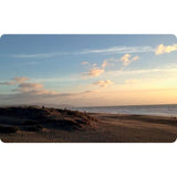 The Cloud Deck beach with sandy dunes under a sunset sky filled with dramatic cloud formations.