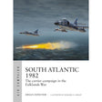 Under a cloudy sky, two military jets—emblems of naval air power—fly above the sea, with one launching a missile toward a burning ship below. The scene graces the cover of South Atlantic 1982, an Osprey title that explores the carrier campaign in the Falklands War by Angus Konstam.