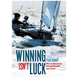 The cover of Bloomsbury's "Winning Isn't Luck" by Fred Imhoff features a sailor in a dinghy with the subtitle, "How to Achieve Sailing Success in Racing Dinghies and Yachts," offering insights into mastering competitive sailing.