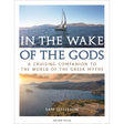 Cover design for "In the Wake of the Gods" features an enchanting voyage through Greek seas, showcasing a serene seascape with a sailboat near distant mountains and ancient Greek ruins by the ocean. The cover includes the author, Sam Jefferson, and is published by Adlard Coles.