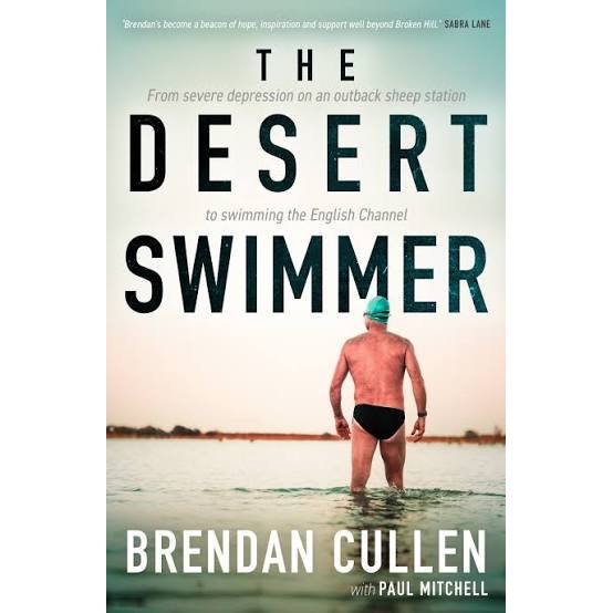 A man in swimwear stands in shallow water, facing away, with the book title "The Desert Swimmer" by Allen & Unwin displayed above—an inspirational true story of overcoming English Channel swim challenges and mental health recovery.