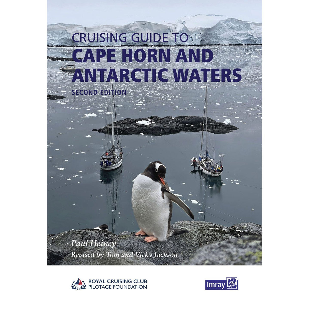 A penguin stands on a rocky shore as two sailboats rest in icy Antarctic waters before snow-capped peaks—a striking cover for Imray’s "Cruising Guide to Cape Horn and Antarctic Waters," with the title and author shown at the top.