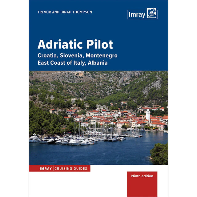 Book cover for Imray's "Adriatic Pilot" cruising guide shows a coastal town with red-roofed buildings, a church, and boats by the water, set before green hills and rocky mountains. Title and author names appear at the top.