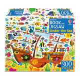 The Usborne Under the Sea Book and Jigsaw is a 300-piece puzzle featuring a vibrant underwater scene with a sunken wooden ship, colorful fish, seaweed, coral, and bubbles—ideal for fun ocean-themed learning.
