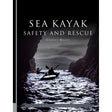 The cover of "Sea Kayak Safety and Rescue" by Pesda Press depicts kayakers navigating waters between dark coastal cliffs under a cloudy sky, reflecting the book’s focus on sea kayak safety and effective kayaking rescue techniques.