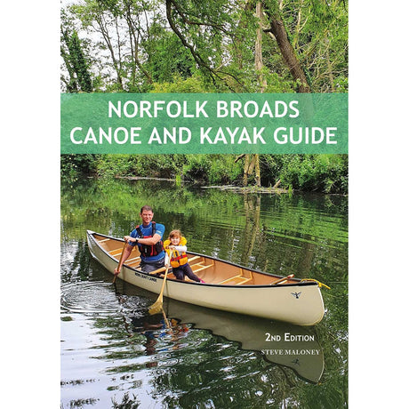 A man and a child paddle a canoe along a peaceful, tree-lined river in the picturesque Norfolk Broads. The book cover displays "Norfolk Broads Canoe and Kayak Guide" by Steve Maloney, published by Pesda Press, providing expert guidance on the top paddling routes across this scenic area.