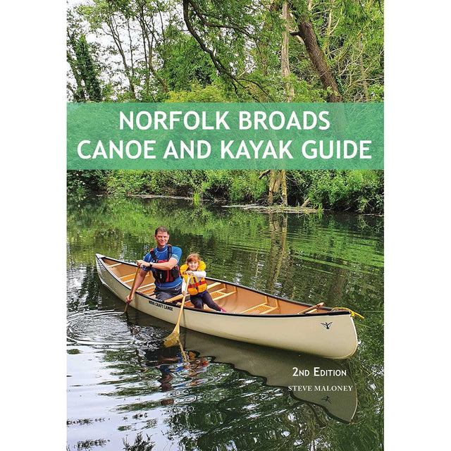 A man and a child paddle a canoe along a peaceful, tree-lined river in the picturesque Norfolk Broads. The book cover displays "Norfolk Broads Canoe and Kayak Guide" by Steve Maloney, published by Pesda Press, providing expert guidance on the top paddling routes across this scenic area.