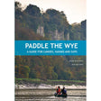 Two people paddle a canoe along the scenic River Wye, gliding past lush trees and dramatic cliffs. Text reads: "Paddle the Wye by Mark Rainsley, 2nd Edition – A comprehensive guide for canoes, kayaks, and paddleboards from Pesda Press.